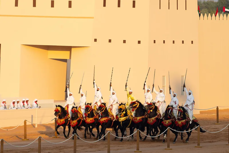al-wathba-tribal-parade-horsemen-rifles-sunset-2023