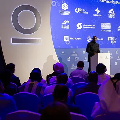 conference-speaker-podium-partner-logos-community-event-uae.webp