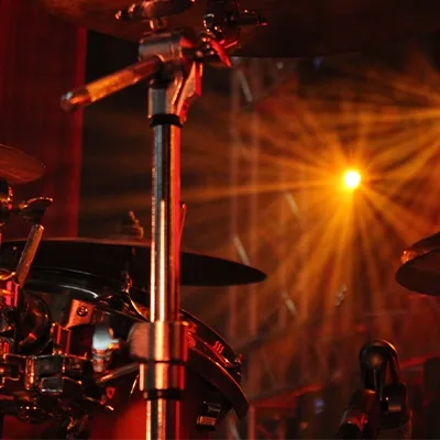 live-music-drum-kit-stage-lighting-closeup-uae.webp