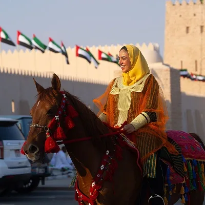 uae-national-day-woman-riding-horse-traditional-attire-uae